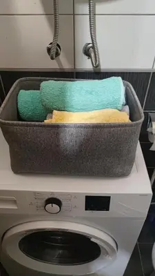a basket of towels sitting on top of a washing machine at Apartman Anika in Soko Banja