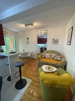 a living room with a couch and a table at Apartman Anika in Soko Banja
