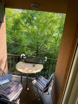a patio with a table and chairs on a balcony at Apartman Anika in Soko Banja