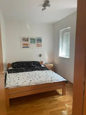 a bedroom with a bed and a window at Apartman Anika in Soko Banja