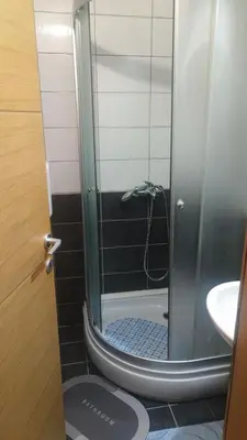 a bathroom with a shower with a toilet and a sink at Apartman Anika in Soko Banja