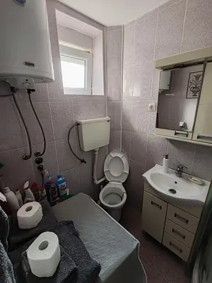 a small bathroom with a toilet and a sink at Happy house in Kruševac