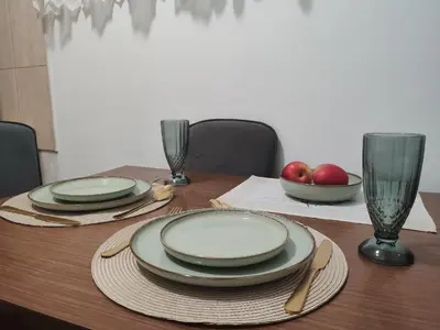 a table with plates and bowls of apples on it at Happy house in Kruševac