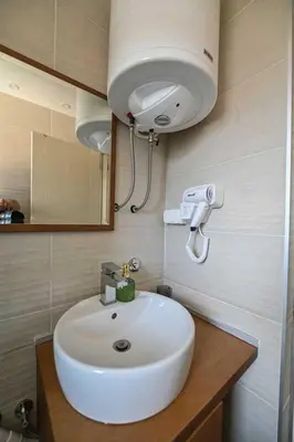 a bathroom with a white sink and a mirror at Zlatnik Vrnjačka Banja in Vrnjačka Banja