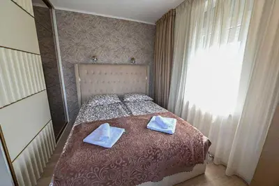 a bedroom with a bed with two towels on it at Zlatnik Vrnjačka Banja in Vrnjačka Banja