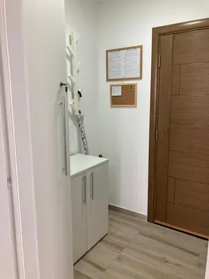 a bathroom with a sink and a brown door at Apartman LOKI in Soko Banja