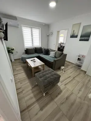 a living room with a couch and a table at Apartman LOKI in Soko Banja