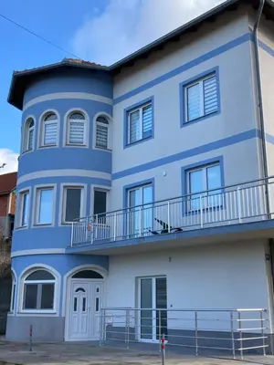 a blue and white building with a balcony at Apartman LOKI in Soko Banja
