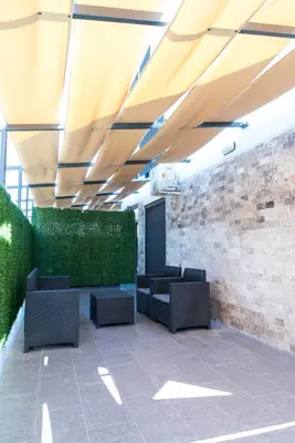 a lobby with chairs and a brick wall at Apartmani Putnik in Vrnjačka Banja