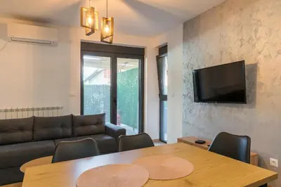 a living room with a table and a couch at Apartmani Putnik in Vrnjačka Banja