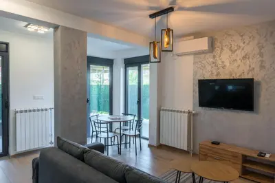 a living room with a couch and a table at Apartmani Putnik in Vrnjačka Banja
