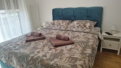 a bed with two brown pillows on top of it at Apartman NEMANJA in Vrnjačka Banja