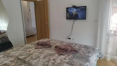two brown shoes sitting on a bed in a room at Apartman NEMANJA in Vrnjačka Banja