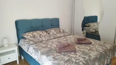 a bed with two towels on it in a bedroom at Apartman NEMANJA in Vrnjačka Banja
