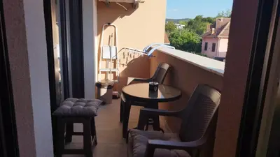 a balcony with a table and chairs on a balcony at Apartman NEMANJA in Vrnjačka Banja