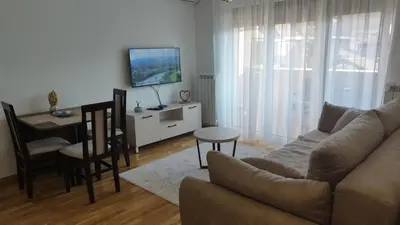 a living room with a couch and a table at Apartman NEMANJA in Vrnjačka Banja