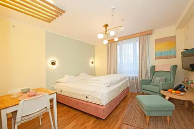 a bedroom with a bed and a table and a chair at Cozy Lodge Kopaonik in Kopaonik
