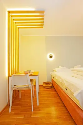 a bedroom with a desk and a bed and a table and chair at Cozy Lodge Kopaonik in Kopaonik