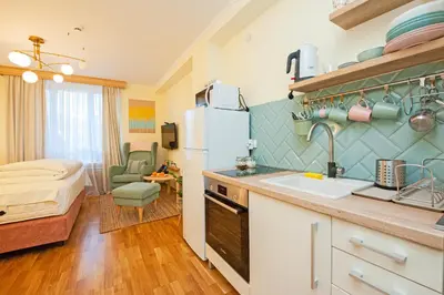 a kitchen with a sink and a room with a bed at Cozy Lodge Kopaonik in Kopaonik