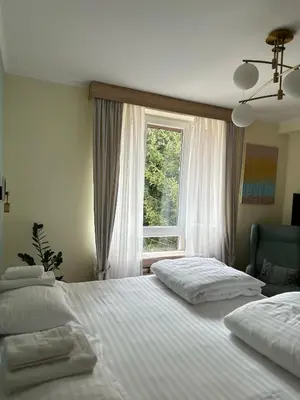 two beds in a bedroom with a window at Cozy Lodge Kopaonik in Kopaonik