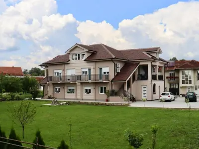 a large house with a green lawn in front of it at Villa Nina in Vrnjci