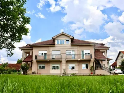 a large house with a green field in front of it at Villa Nina in Vrnjci