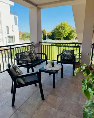 three chairs and a table on a balcony with a view at Villa Nina in Vrnjci