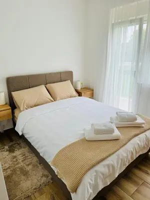 a bedroom with a large bed with two towels on it at Villa Nina in Vrnjci