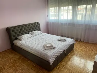 a bedroom with a bed with two towels on it at Niki Apartman in Kruševac
