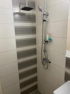 a shower with a glass door in a bathroom at Niki Apartman in Kruševac