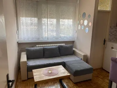a living room with a couch and a table at Niki Apartman in Kruševac