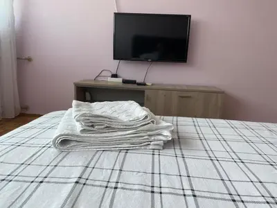 a pile of white towels sitting on a bed at Niki Apartman in Kruševac