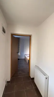 a hallway with a room with a bed and a door at Krupajska bajka in Krepoljin