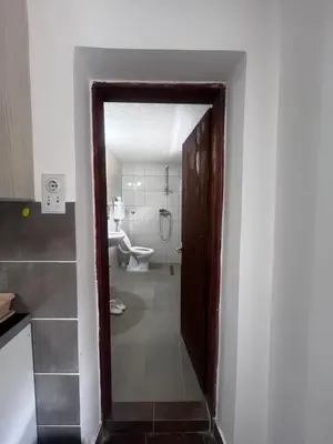 a doorway to a bathroom with a toilet and a sink at Krupajska bajka in Krepoljin