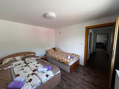 a bedroom with two beds and a couch in it at Krupajska bajka in Krepoljin