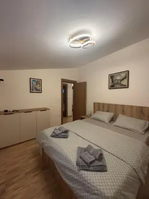 a bedroom with a bed with two towels on it at Kraljica apartman in Vrnjačka Banja