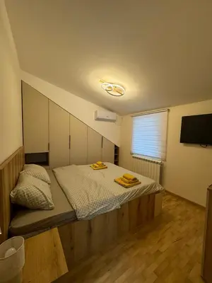 a bedroom with a bed with two towels on it at Kraljica apartman in Vrnjačka Banja