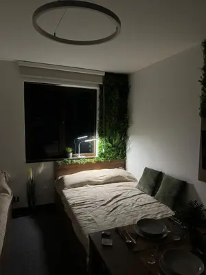 a bedroom with a bed and a window and a table at La familia Kopaonik in Brzeće