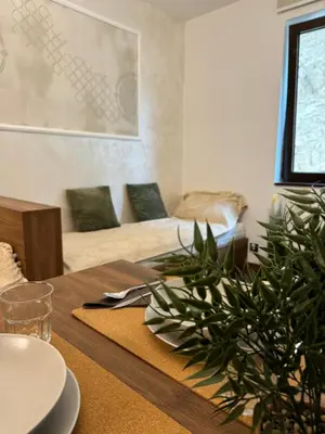 a dining room with a table with a plant on it at La familia Kopaonik in Brzeće