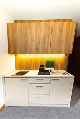 a kitchen with a white counter and a sink at La familia Kopaonik in Brzeće