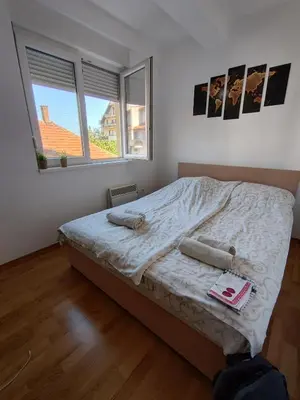 a bedroom with a bed and a window at Sunrise apartment Sokobanja in Soko Banja