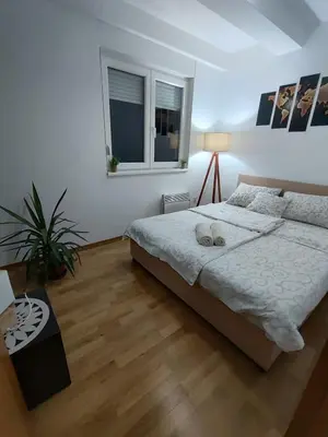 a bedroom with a large bed and a window at Sunrise apartment Sokobanja in Soko Banja