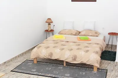 a bedroom with a bed with two pillows on it at Apartmani Borovi in Pirot