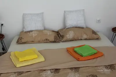 two towels on a bed with pillows on it at Apartmani Borovi in Pirot