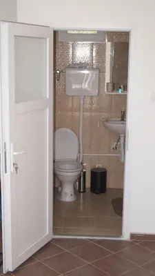 a bathroom with a toilet and a sink at Apartmani Borovi in Pirot