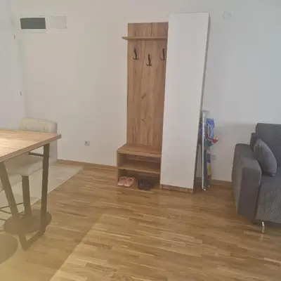 a living room with a table and a couch at MB LUX Residence in Vrnjačka Banja