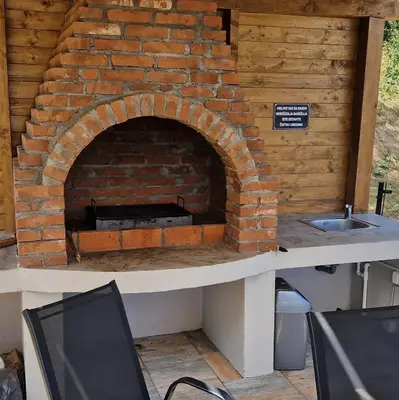 a brick oven with a sink on a table at MB LUX Residence in Vrnjačka Banja
