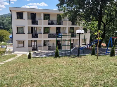 a building with a playground in front of it at MB LUX Residence in Vrnjačka Banja