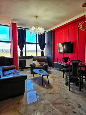 a living room with red walls and couches at Red Diamond in Niš