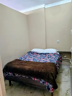 a small bedroom with a bed in a room at Red Diamond in Niš